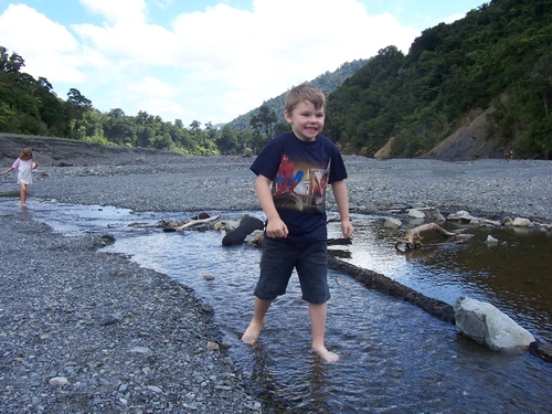 Kids playing in the Turere Stream at its outlet into the Orongorongo River