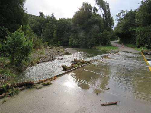 The flooded ford and fish ladder shown before the digger removed the debris 