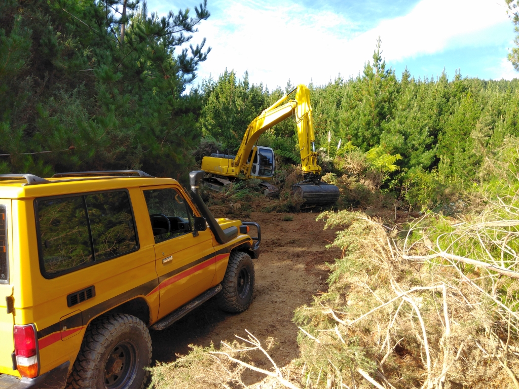 Excavator and 4WD building the new access road for ground control contractors along the 200 metre contour